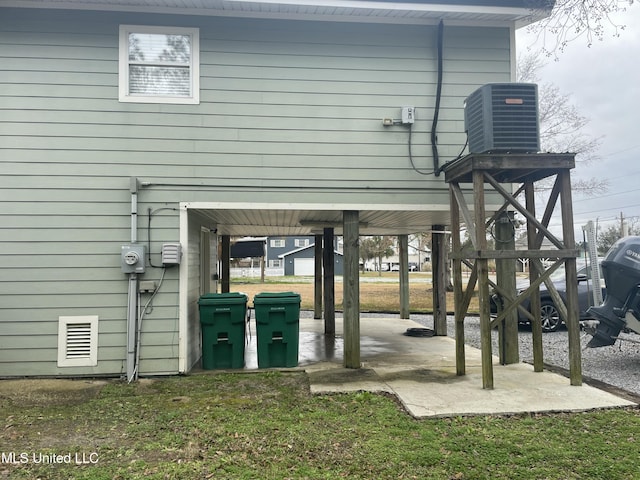 back of property featuring visible vents, central AC, and a patio