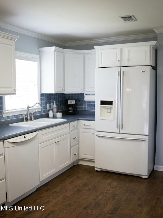 kitchen with ornamental molding, white appliances, visible vents, and white cabinetry