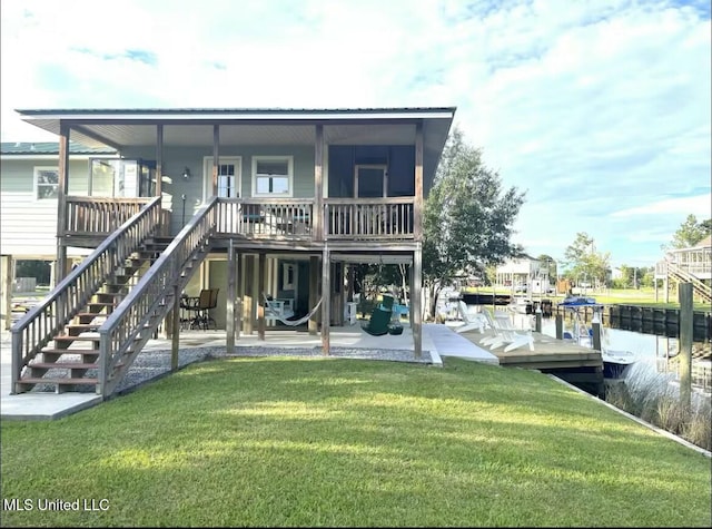 back of property with a patio area, a lawn, and stairs