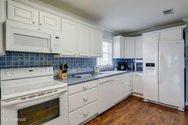 kitchen with dark wood finished floors, visible vents, decorative backsplash, a sink, and white appliances