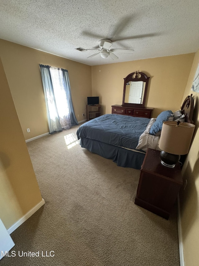 bedroom with carpet flooring, a textured ceiling, and ceiling fan