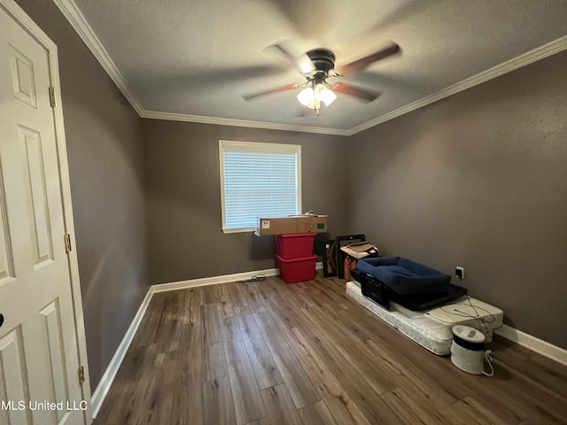 interior space featuring ornamental molding, ceiling fan, hardwood / wood-style floors, and baseboards