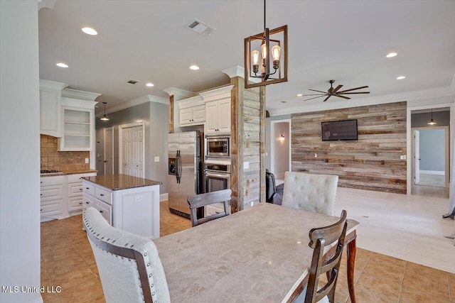 107 Bridgeton Ct, Canton, MS 39046 - dining area with wood walls, recessed lighting, light tile patterned floors, ornamental molding, and ceiling fan