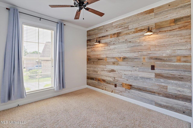 107 Bridgeton Ct, Canton, MS 39046 - carpeted empty room with wood walls, a ceiling fan, and baseboards