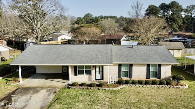 ranch-style house featuring an attached carport, driveway, brick siding, and a front yard