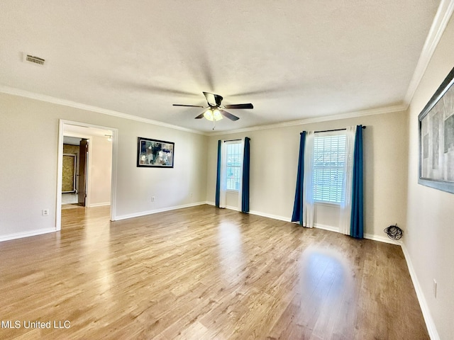 unfurnished room featuring light wood finished floors, visible vents, a ceiling fan, and ornamental molding