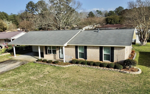 ranch-style house featuring brick siding, an attached carport, driveway, and a front yard