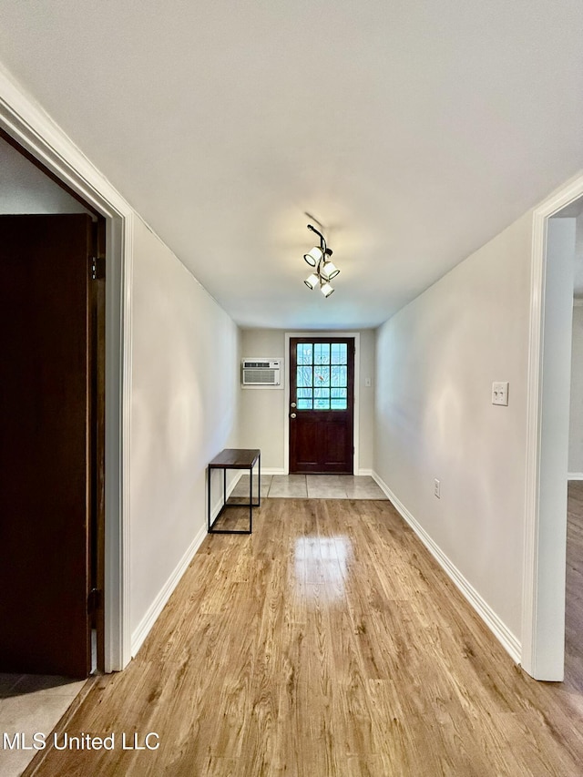 unfurnished room with baseboards and light wood-style flooring