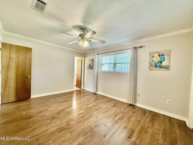 unfurnished room featuring ornamental molding, a textured ceiling, ceiling fan, and wood finished floors