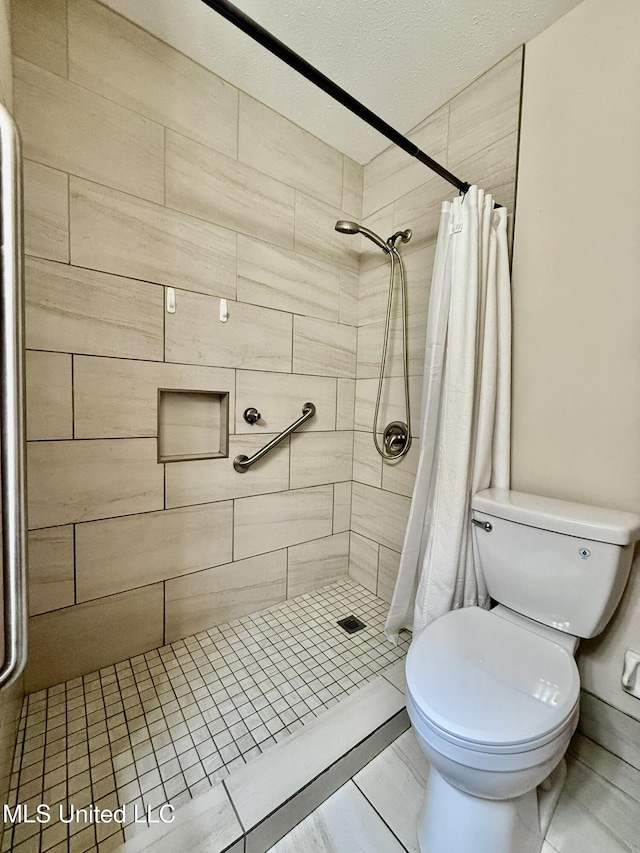 bathroom with toilet and a stall shower