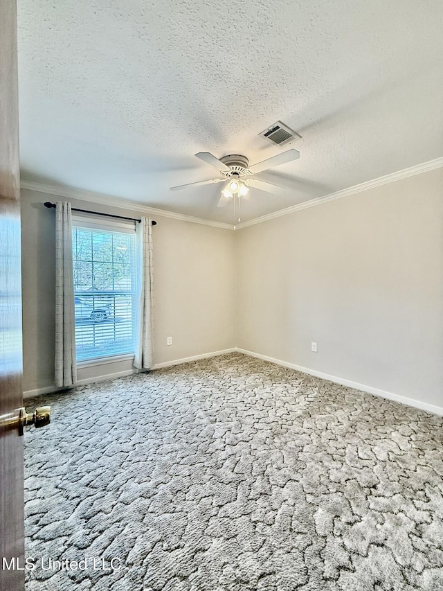 spare room with crown molding, visible vents, and ceiling fan