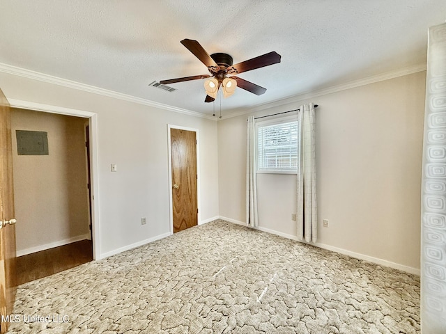 unfurnished bedroom with visible vents, baseboards, a textured ceiling, and ornamental molding