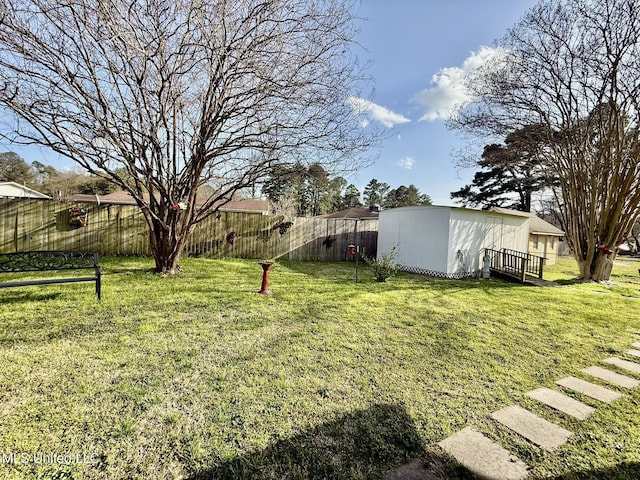 view of yard featuring an outbuilding and a fenced backyard