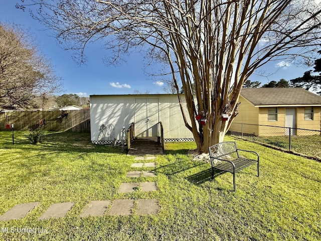 view of yard with an outdoor structure and a fenced backyard