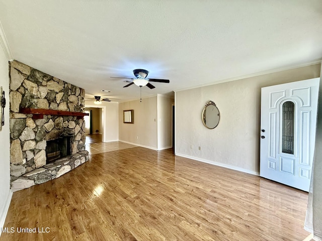 unfurnished living room with wood finished floors, a ceiling fan, and ornamental molding