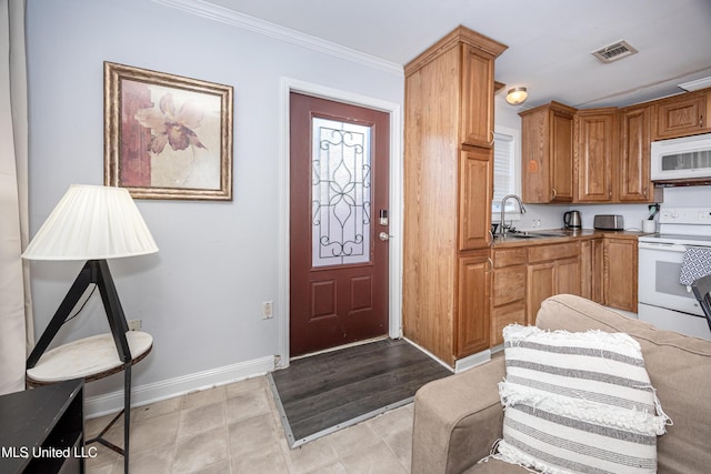 kitchen with crown molding, sink, and white appliances