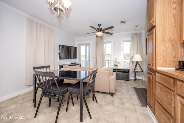 dining area featuring ceiling fan with notable chandelier and crown molding