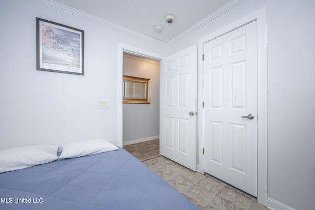 tiled bedroom with a closet and crown molding