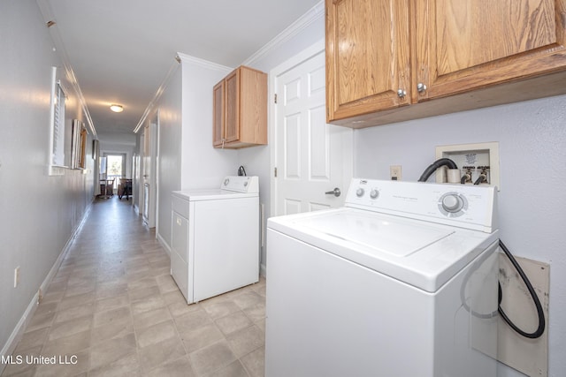 washroom featuring independent washer and dryer, ornamental molding, and cabinets