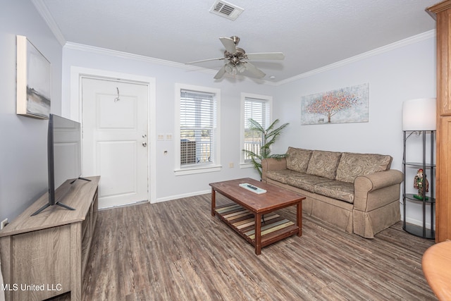 living room featuring ceiling fan, dark hardwood / wood-style flooring, ornamental molding, and a textured ceiling