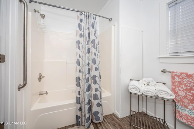 bathroom with ornamental molding, shower / bath combination with curtain, and hardwood / wood-style flooring