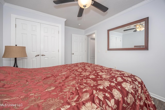 bedroom featuring ceiling fan, a closet, and crown molding