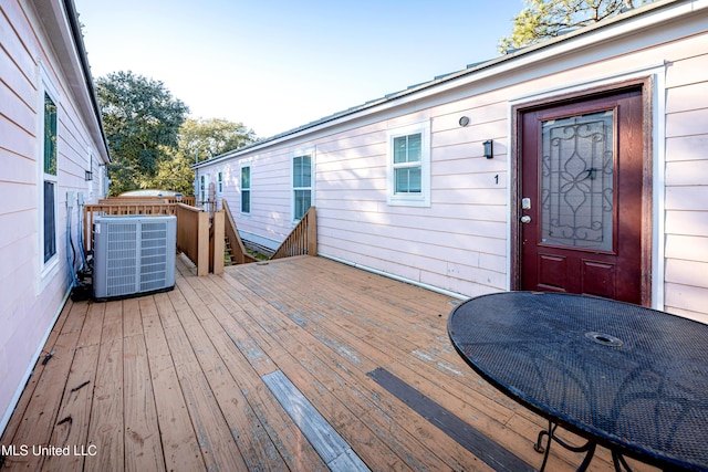 wooden terrace featuring cooling unit