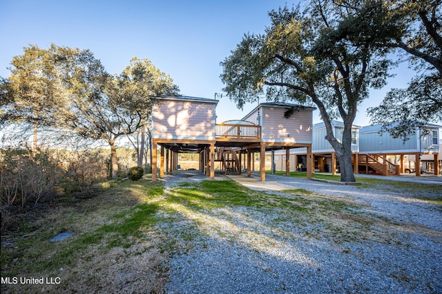 rear view of house featuring a yard