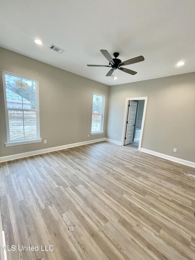 empty room featuring ceiling fan and light wood-type flooring