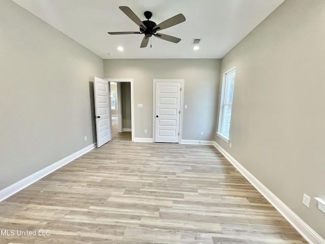 unfurnished bedroom with ceiling fan and light wood-type flooring