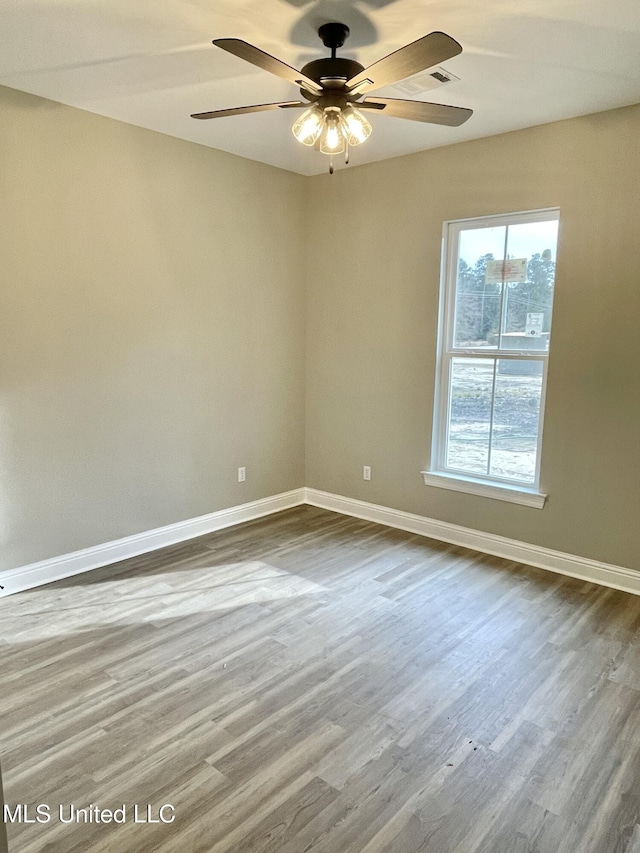 empty room featuring hardwood / wood-style flooring and ceiling fan