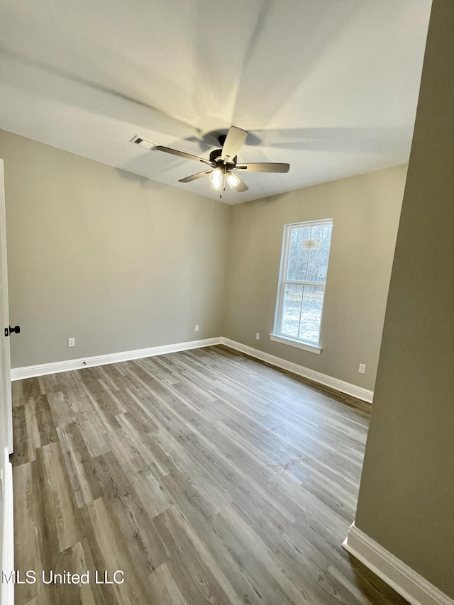 empty room featuring hardwood / wood-style floors and ceiling fan