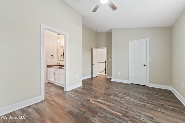 unfurnished bedroom with ceiling fan, dark hardwood / wood-style floors, ensuite bath, vaulted ceiling, and sink