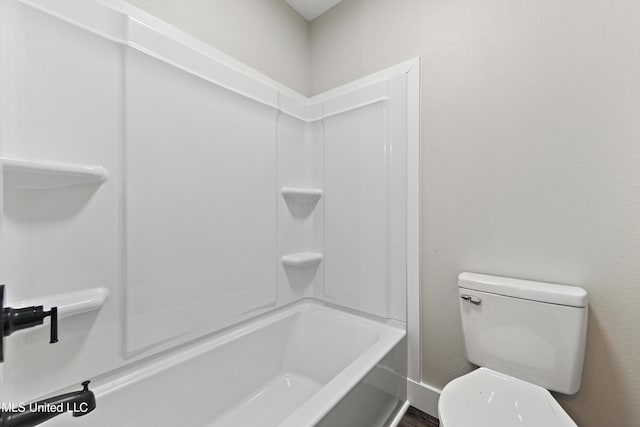 bathroom featuring toilet and  shower combination