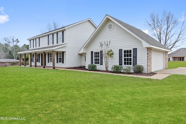 view of front of home with a garage, a front lawn, and a porch