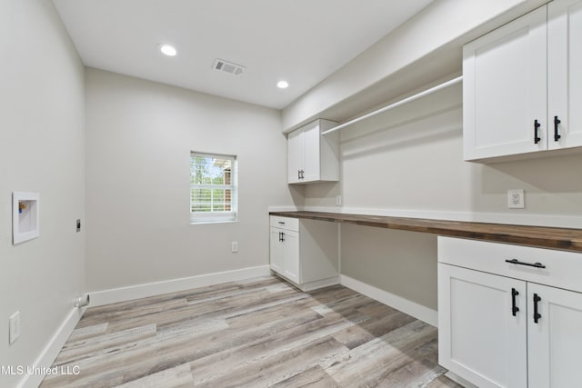 laundry area featuring washer hookup, cabinets, light wood-type flooring, and hookup for an electric dryer