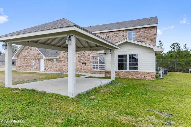 rear view of property with central AC unit, a gazebo, a lawn, and a patio