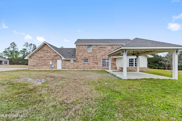 rear view of house with a patio area and a yard