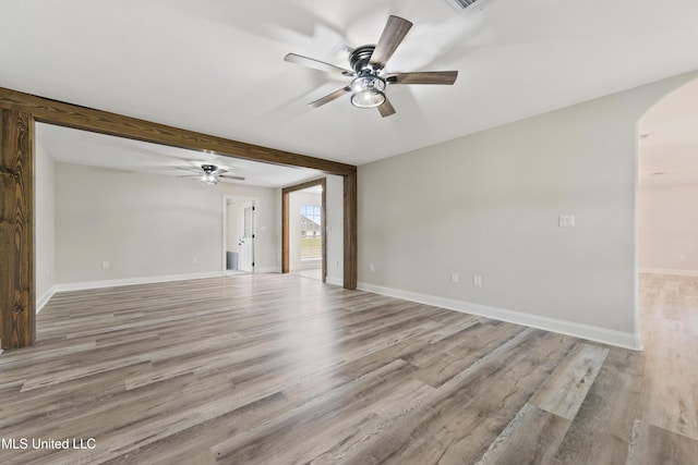 unfurnished living room with ceiling fan, beamed ceiling, and light hardwood / wood-style floors