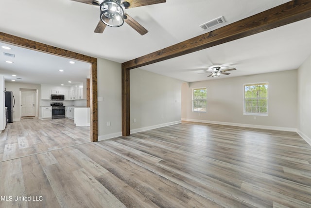 unfurnished living room with light hardwood / wood-style floors and ceiling fan