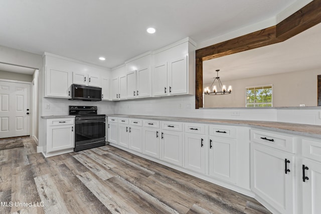 kitchen featuring an inviting chandelier, white cabinetry, black electric range oven, and tasteful backsplash