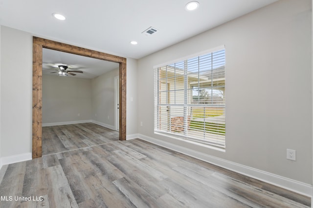 spare room with ceiling fan and light hardwood / wood-style flooring