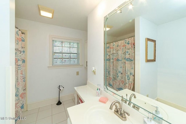 16063 W Daytona Dr, Pearlington, MS 39572 - full bathroom featuring tile patterned floors, vanity, and baseboards
