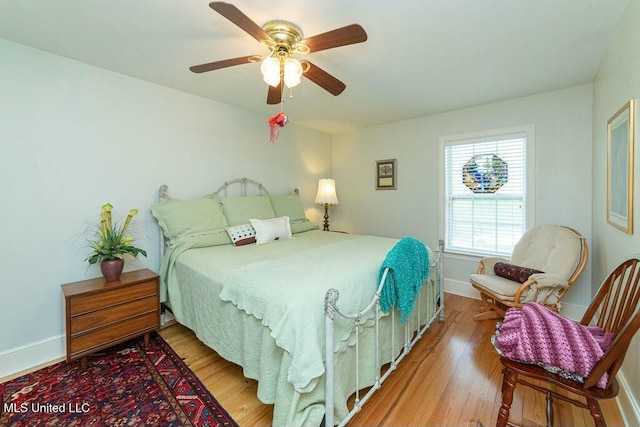 16063 W Daytona Dr, Pearlington, MS 39572 - bedroom with baseboards, wood finished floors, and a ceiling fan