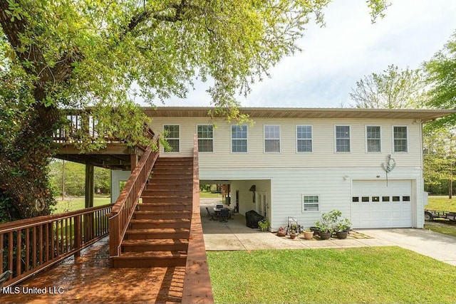 16063 W Daytona Dr, Pearlington, MS 39572 - view of front of home featuring a wooden deck, an attached garage, stairs, a front yard, and driveway