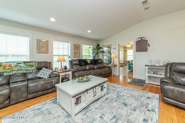16063 W Daytona Dr, Pearlington, MS 39572 - living room with a wealth of natural light, visible vents, light wood-style floors, and vaulted ceiling