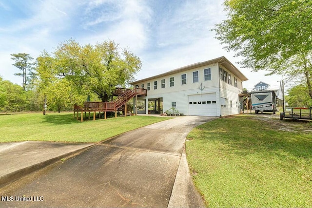 16063 W Daytona Dr, Pearlington, MS 39572 - view of front facade featuring a wooden deck, a garage, concrete driveway, stairway, and a front yard
