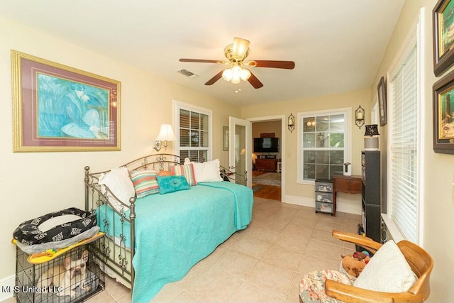 16063 W Daytona Dr, Pearlington, MS 39572 - tiled bedroom with baseboards, visible vents, and a ceiling fan