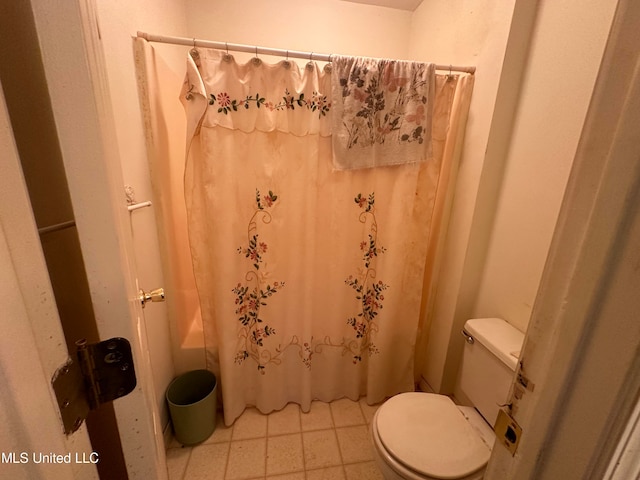 bathroom featuring toilet and a shower with curtain