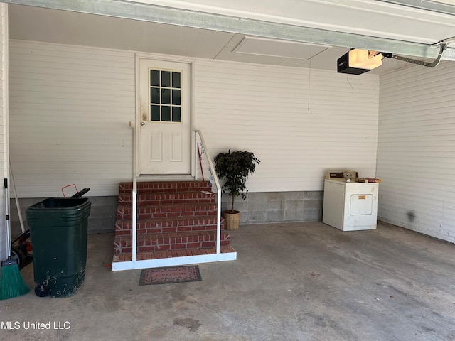 exterior space with washer / dryer and a garage door opener